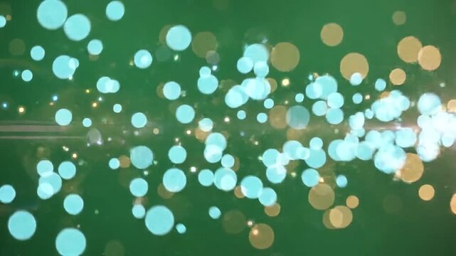 Golden bokeh lights on green screen. Abstract glowing particles for video compositing.