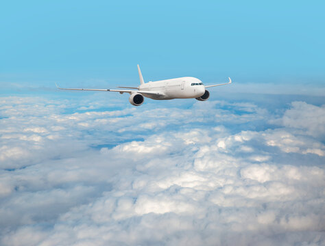 White passenger airplane flying in the sky amazing storm clouds in the background - Travel by air transport