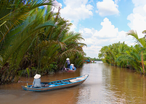 Fisherman is fishing in Mekong river in the morning - People boating in the delta of Mekong river, Vietnam, Asia