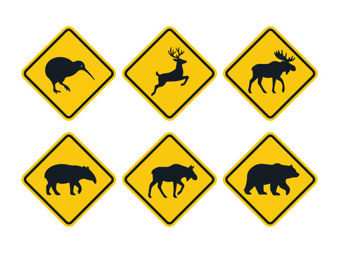 Collection of yellow road signs featuring various animal crossing symbols including deer bear and moose for wildlife