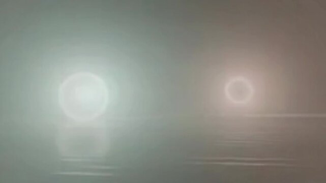Abstract background with glowing neon ring light and blurred reflection on smooth water surface in seamless loop