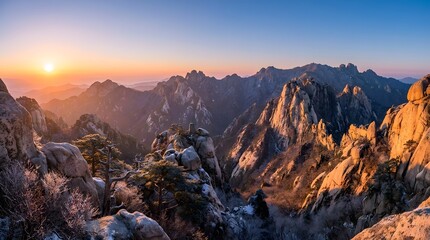 Naklejka premium Sunset and Sunrise Over Majestic Snow Capped Mountains with Dramatic Clouds, Rocky Peaks and Panoramic Winter Landscape in Nature for Travel Background
