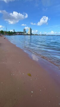 Scenic vertical video featuring turquoise seawater, soft waves, blue sky, and tropical coastline, creating a peaceful atmosphere for summer vacations, beach resorts, wellness, and leisure travel conce