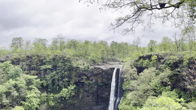 Scenic Waterfall Flowing Through Lush Green Forest with Natural Ambient Sound