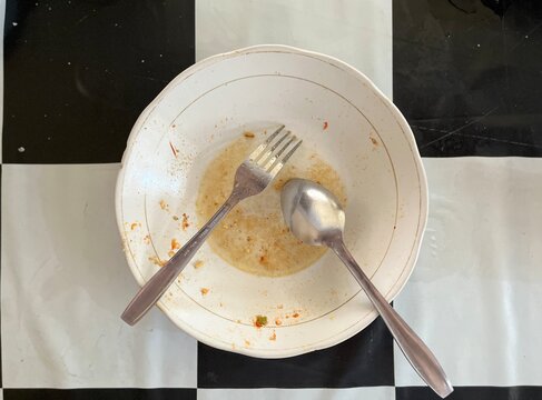 Dirty dishes and a spoon and fork
