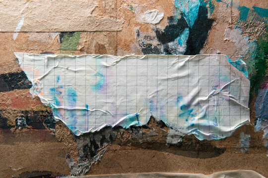 Torn Graph Paper Pasted on Grunge Wall with Paint Stains Background for Text Copyspace