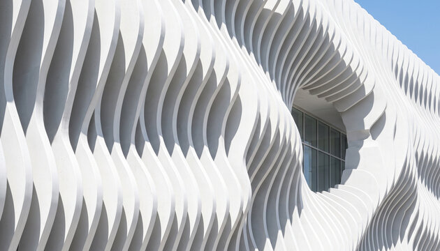 Modern white parametric building facade with wavy architectural lines and window detail, futuristic exterior design