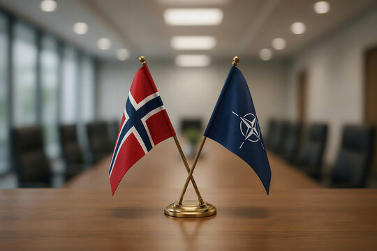 Small desk flags of norway and nato crossed on a wooden table in a boardroom with a blurred background, of chairs and, a table