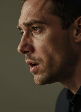 Close Profile Portrait Of Adult Male With Fair Skin Gaze Directed Slightly Upwards Towards Right Side Giving Contemplative