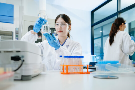 A scientific research team collaborating in a modern laboratory, conducting experiments, analyzing samples, and using advanced lab equipment