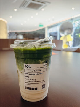 Layered Iced Ceremonial Matcha Green Tea Latte with Fresh Milk in a Clear Plastic Takeout Cup at SOL Coffee, True Digital Park, Bangkok Thailand