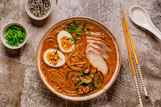 Delicious bowl of ramen with chicken, eggs, mushrooms