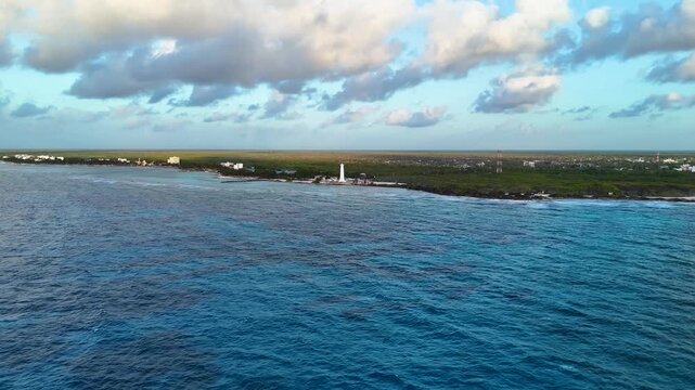 Impressive panoramic aerial view of Mahahual Coastline surrounded by a tropical jungle in Mexico at sunrise - Revealing forwards drone shot