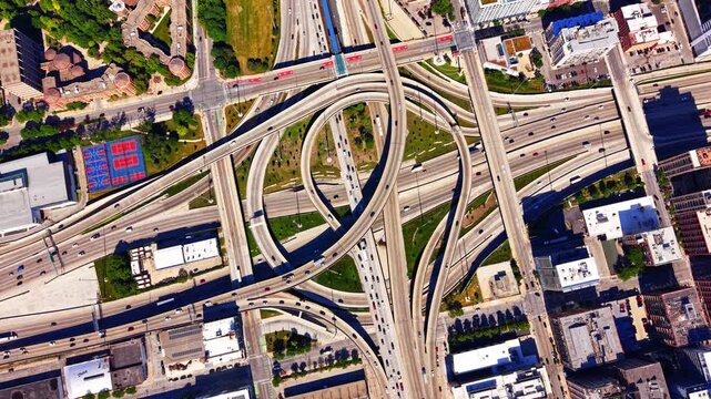 Aerial view of circular highway interchange i290 and i90, Chicago Illinois. Looping expressway ramps, sports courts and traffic lanes near the city center.