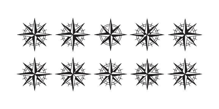 Vintage nautical compass rose and wind rose symbols set for marine navigation and maritime charting.