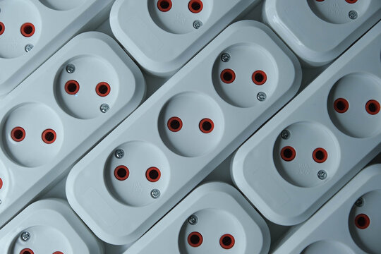 row of white electrical outlets with red and black accents