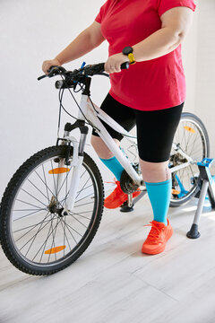Person using smart watch for home bike training