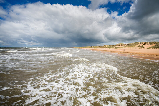 Dark cloudy sky over long sandy beach near Mellbystrand in Laholm Municipality, Sweden