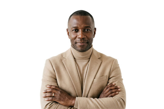 Man looks at camera with arms crossed while standing in light beige suit. Clean white background setting emphasizes professionalism. Concept of business, leadership, self-assurance