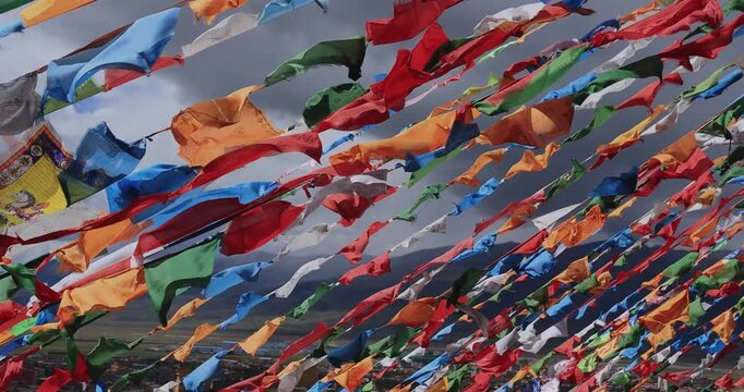 The Changqing Chunker Temple  in Litang, China. Many colourful prayer flags on the mountain top beside the temple.Spirituality and meditation.