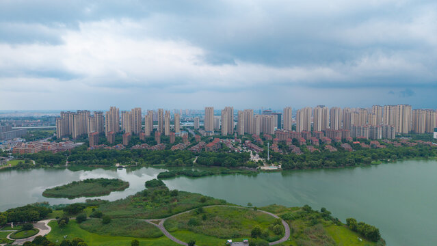 Aerial view of waterside residential community beside wetland lake under cloudy sky