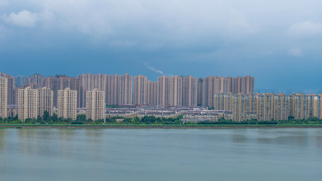 Aerial view of waterside residential community beside wetland lake under cloudy sky