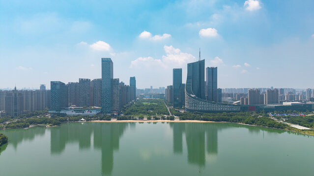 Aerial view of modern city CBD skyline with skyscrapers reflecting in calm lake water