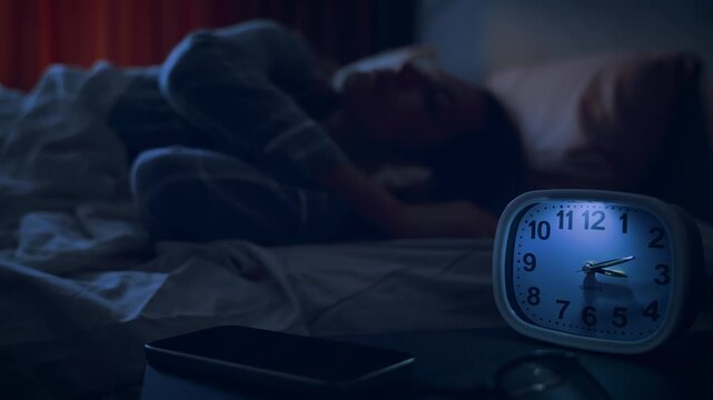 silhouette sad woman liying in bed awake suffering from incomnia anxious thought, looking at late time alarm clock. tired girl unable can't fall sleep. night dark room, stress health problem feel bad