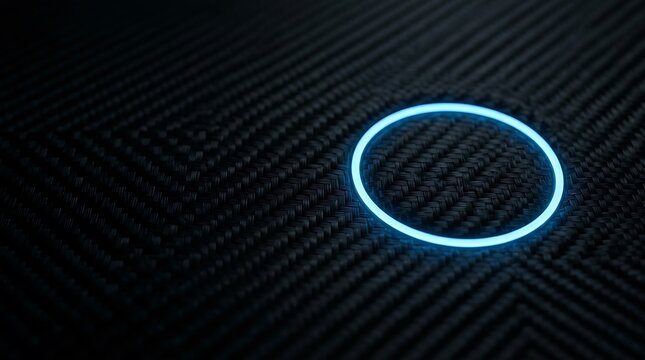Bright cyan neon circle ring light glowing on a dark black carbon fiber background, with a geometric, weave pattern and, subtle depth of field