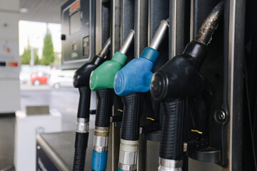 Fuel pump nozzles aligned. Gas station equipment. Refueling service background. Petrol dispenser detail. Energy transport infrastructure. © Paweł Michałowski