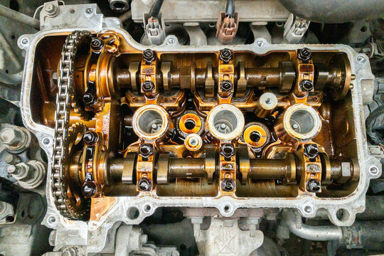 Banten, Indonesia-2026, Aug 1: Engine internals exposed, showing valves and camshafts. Metal parts gleam with precise, industrial craftsmanship. Mechanical complexity suggests maintenance or repair wo