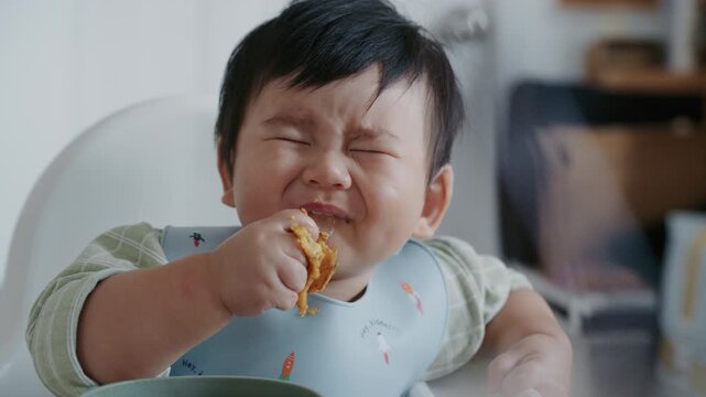 Cute Asian Toddler Eating Finger Food at Home, Healthy Childhood and Family Lifestyle in 4K