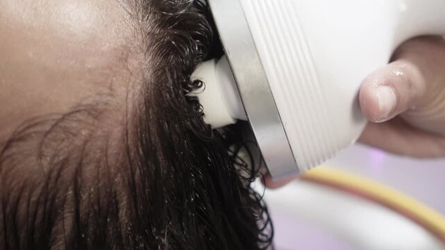 Electric scalp massager treatment at a Japanese head spa to stimulate circulation, cleanse the scalp, and promote relaxation and hair wellness.