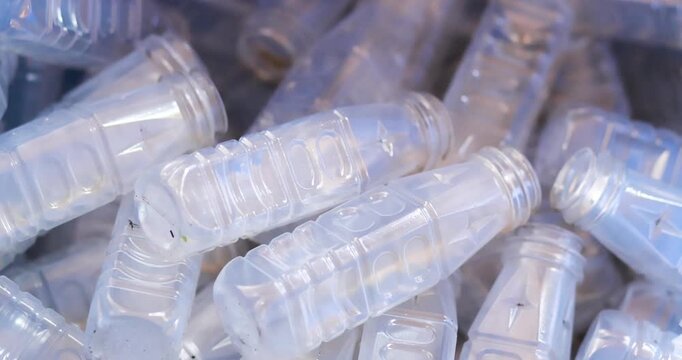 Used clear PET plastic bottles in a recycling bin. plastic waste management, sustainability, circular economy, and environmental conservation concepts, close-up