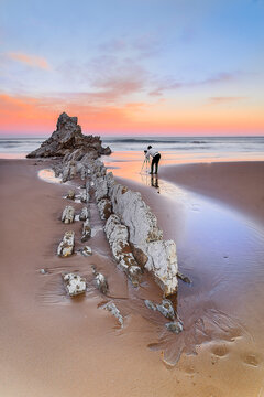  Dramatic sun rays over flysch rock formations at Sopelana beach in Bizkaia Basque Country during long exposure seascape photography