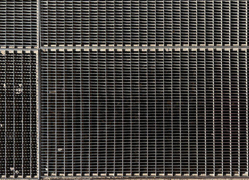 Texture of an entrance dirt-trapping grate in front of a shopping mall entrance. Metal grid background
