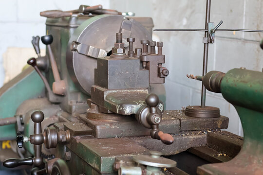 Industrial heavy duty metal lathe machine toolpost, carriage, and chuck assembly.