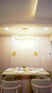Modern luxury chandelier in a bright room. Elegant gold lighting fixture for home interior.