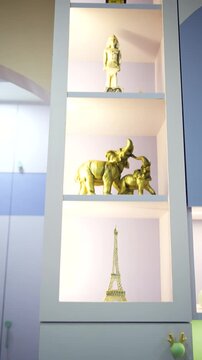 Golden decorative statues on a shelf. Luxury home interior decor with traditional figurines.