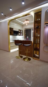 Modern luxury kitchen interior design. Contemporary home bar area with elegant gold accents.