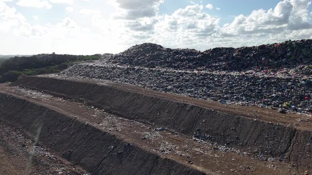 Aerial view of massive landfill piles and garbage mounds stretching across the landscape, illustrating waste pollution, environmental degradation and the scale of modern refuse management under