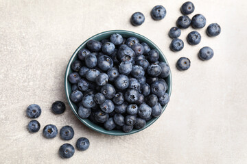 Fresh ripe blueberries in bowl on grey table, flat lay © New Africa