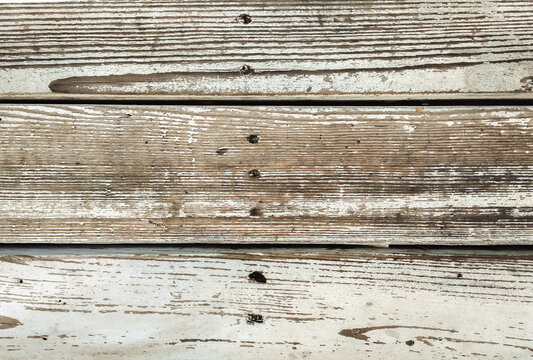 Old vintage white cracked paint on wooden bench. Texture and grunge background. Top view.