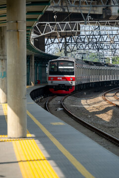 Jakarta, Indonesia - July 29, 2026: KAI Commuter JR 205 series train arrives at the platform beneath the Jakarta Inner Ring Road at JIS Station.