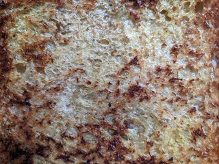 toast taken from a top view, with a crispy texture in dim lighting © Setarr