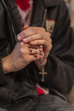 Young man praying with rosary, Paris, France