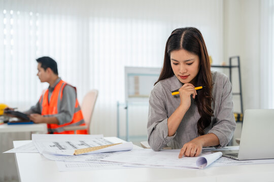 professional architects, engineers working on new construction project of building .