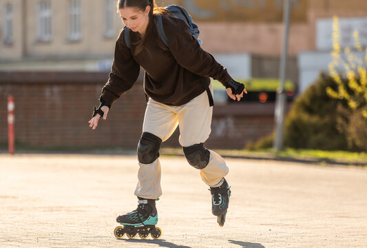 Close-Up Of Teen Roller-Skating In Parking Lot