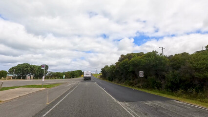 Fototapeta premium Vehicle Driving Along the Great Ocean Road in Victoria Australia