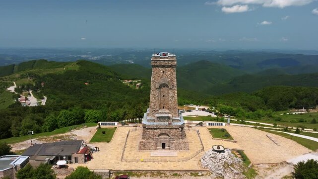 Shipka, Bulgaria - June 14, 2025: Shipka Pass monument Freedom Monument stone tower aerial view surrounding green hills valley Bulgaria historical landmark tourism spot